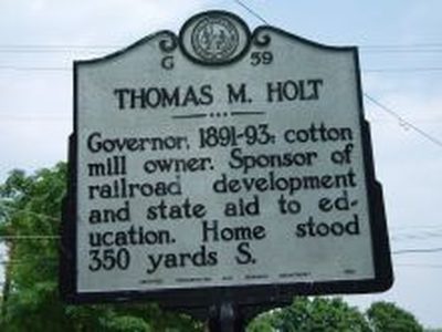 THOMAS M. HOLT