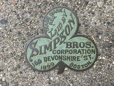 Simpson Bros. Clover-shaped pavement plaque, 1899