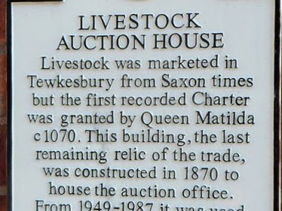 White plaque on the former livestock auction house, Tewkesbury