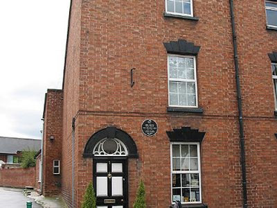House with black plaque